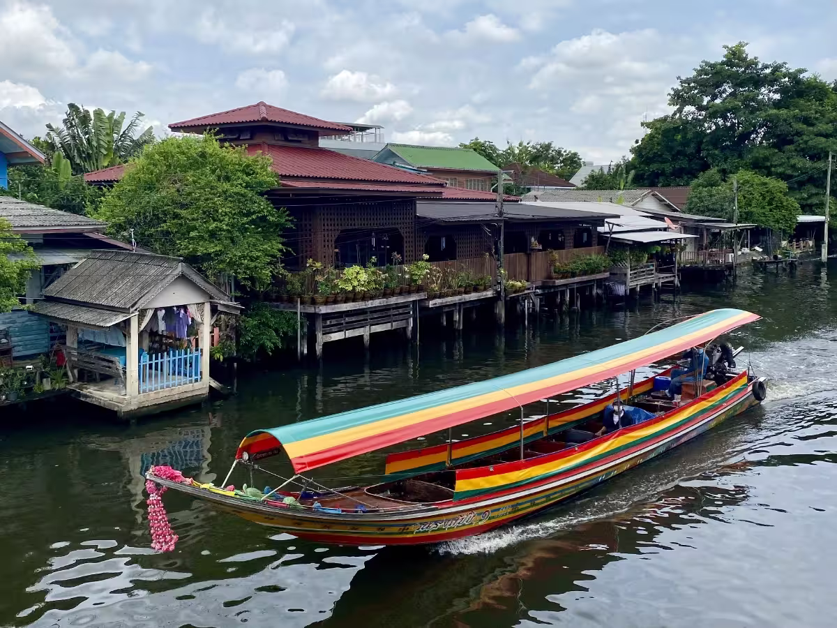 Traditional longtail boat navigating Bangkoks Chao Phraya canals