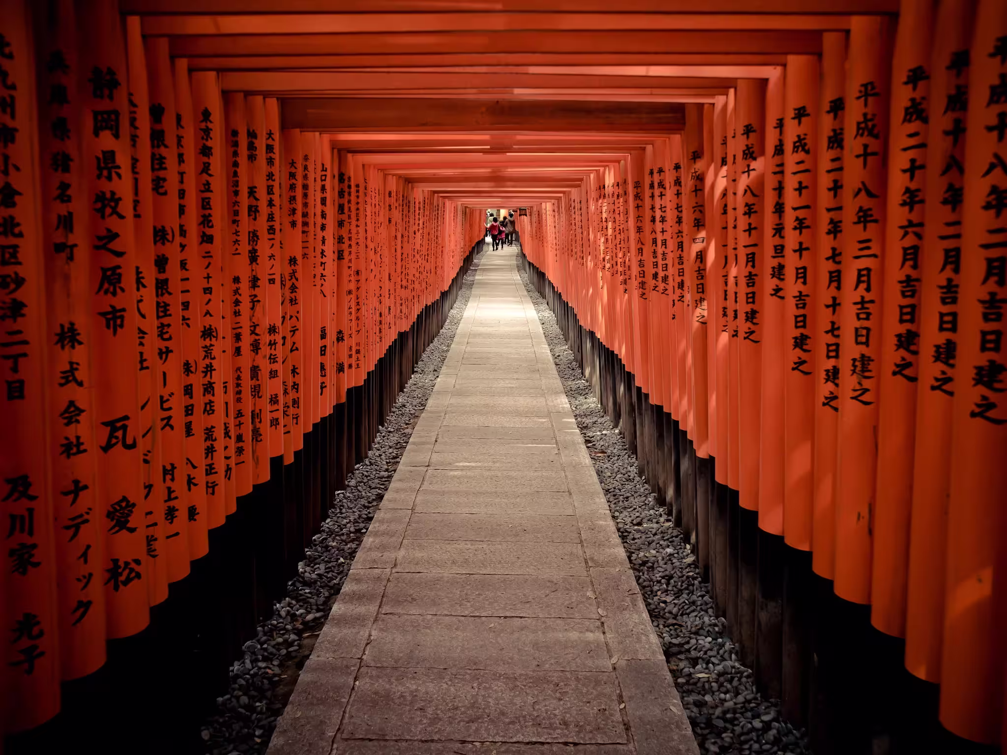 Corridor of thousands of vermilion torii gates at Fushimi Inari